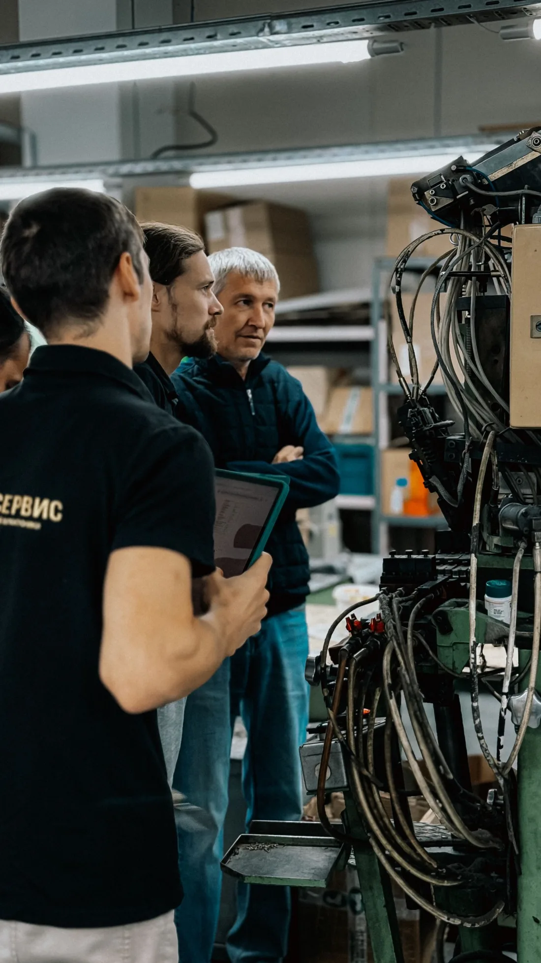 Engineers discussing industrial machinery together