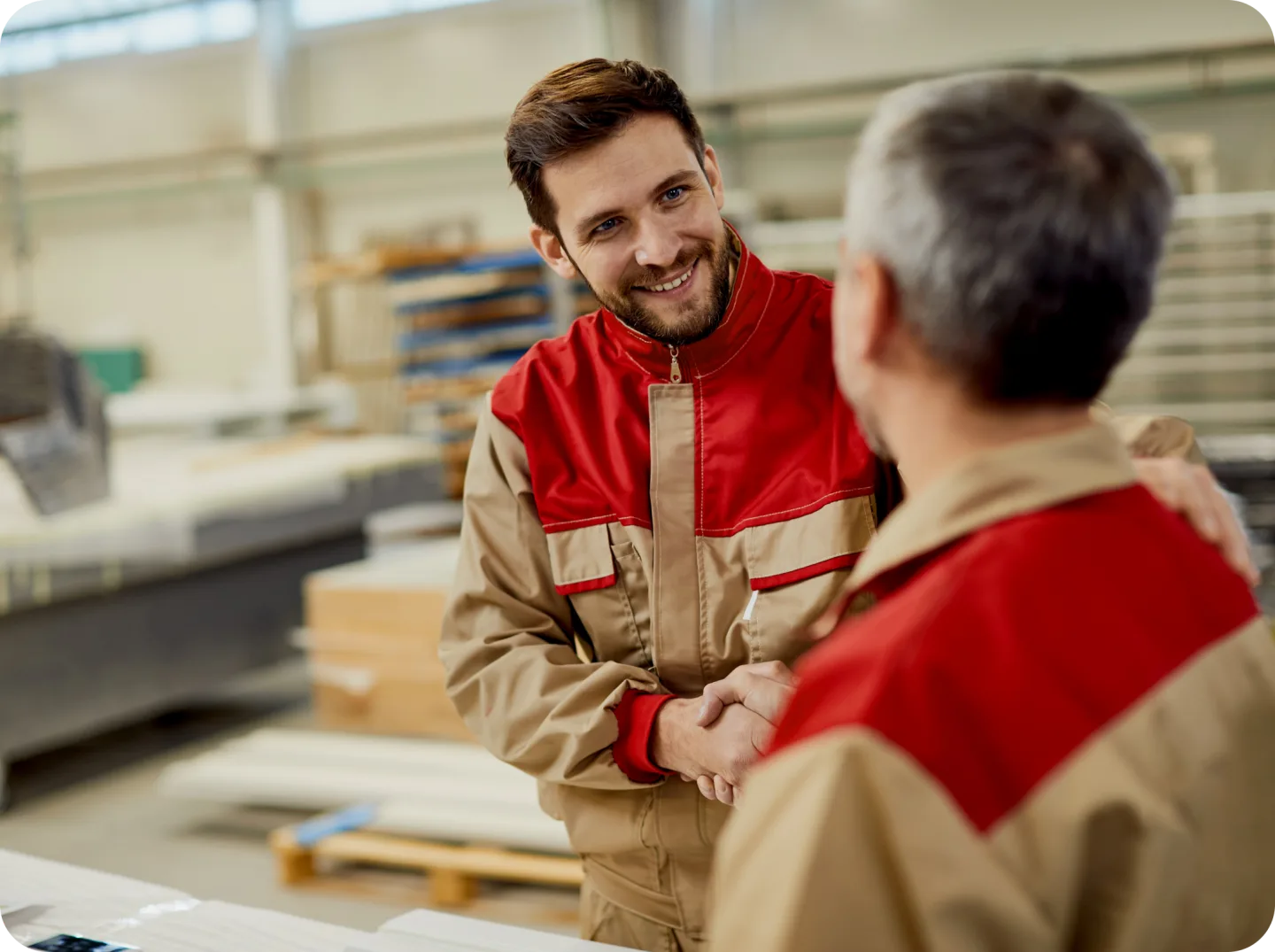 Two colleagues in conversation on a factory floor